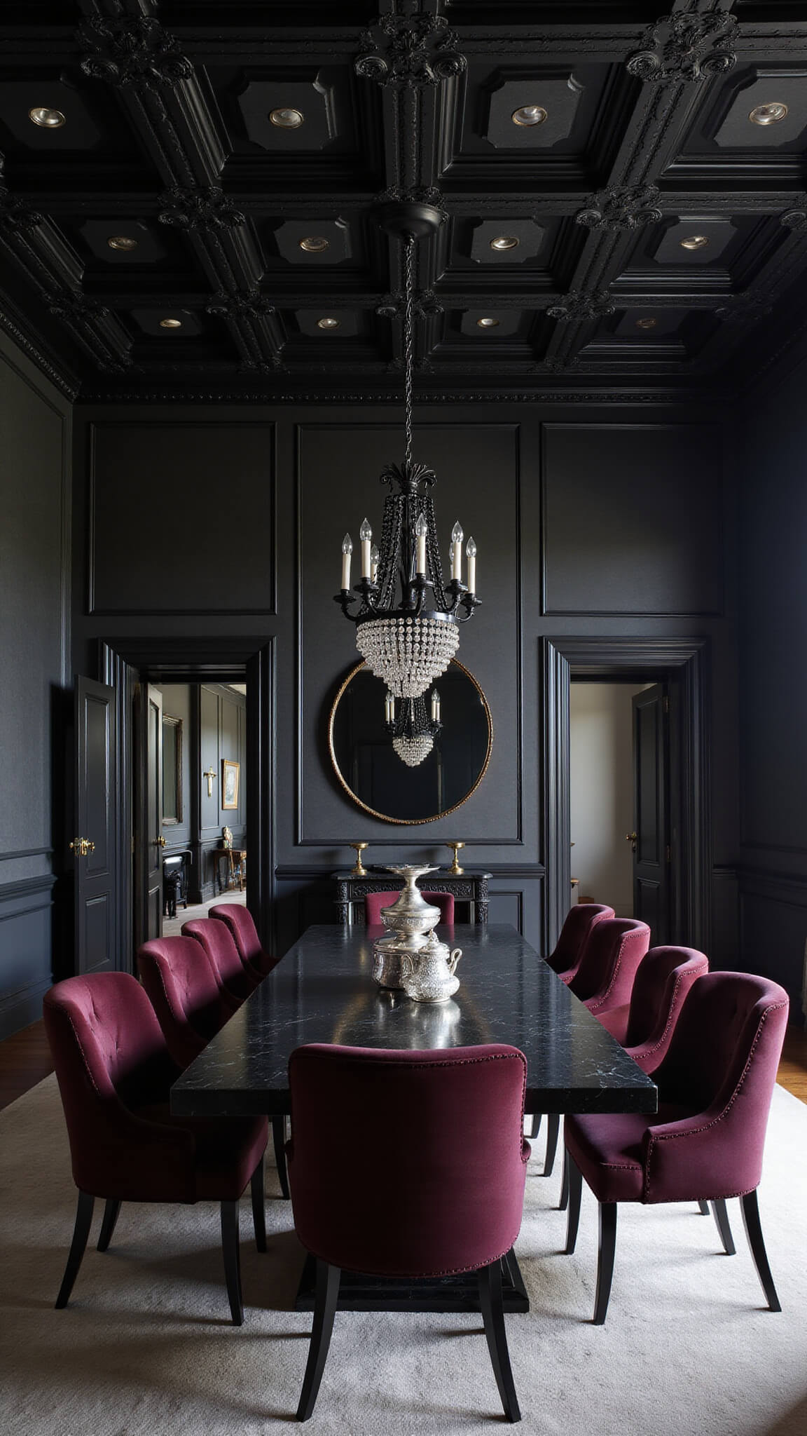 Moody minimalist gothic dining room with black coffered ceiling, ebony table, wine velvet chairs, and storm-lit ambiance.