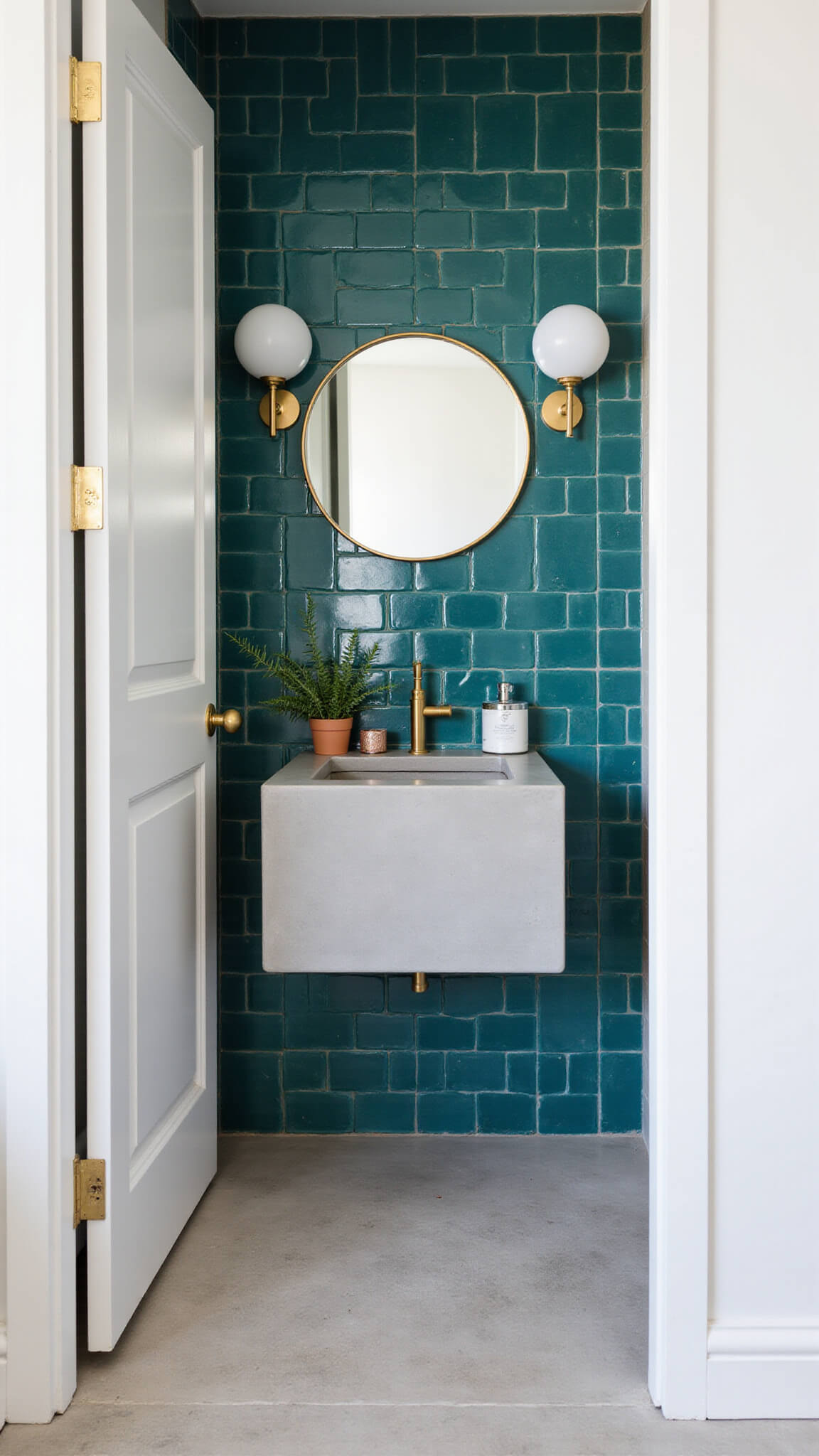 Compact 6x8ft guest bathroom with turquoise graphic tiles, round brass mirror, floating concrete vanity, modern globe sconce, and geometric decor in bright mid-morning light.