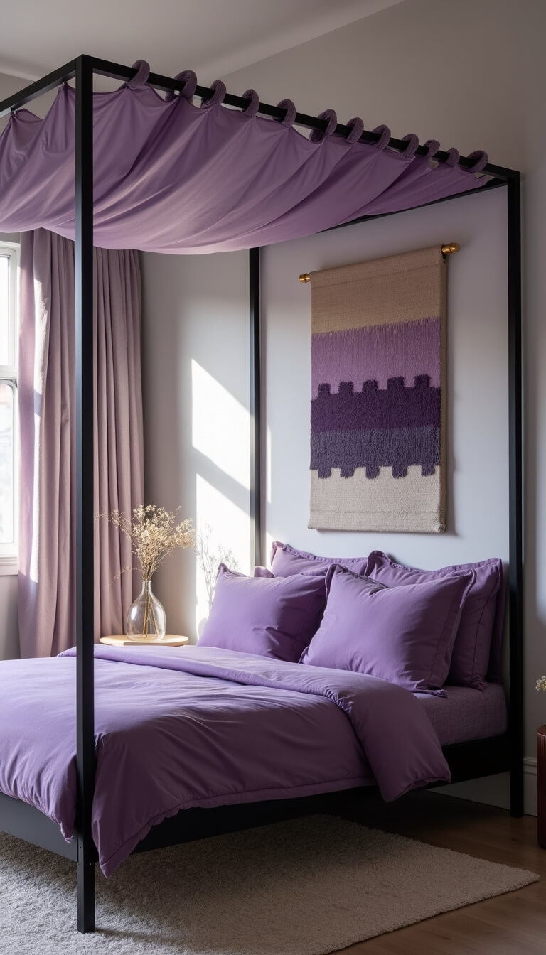 Minimalist 14x14ft bedroom with matte black four-poster bed, lavender canopy, layered purple bedding, abstract artwork, handwoven wall hanging, and dramatic afternoon shadows.